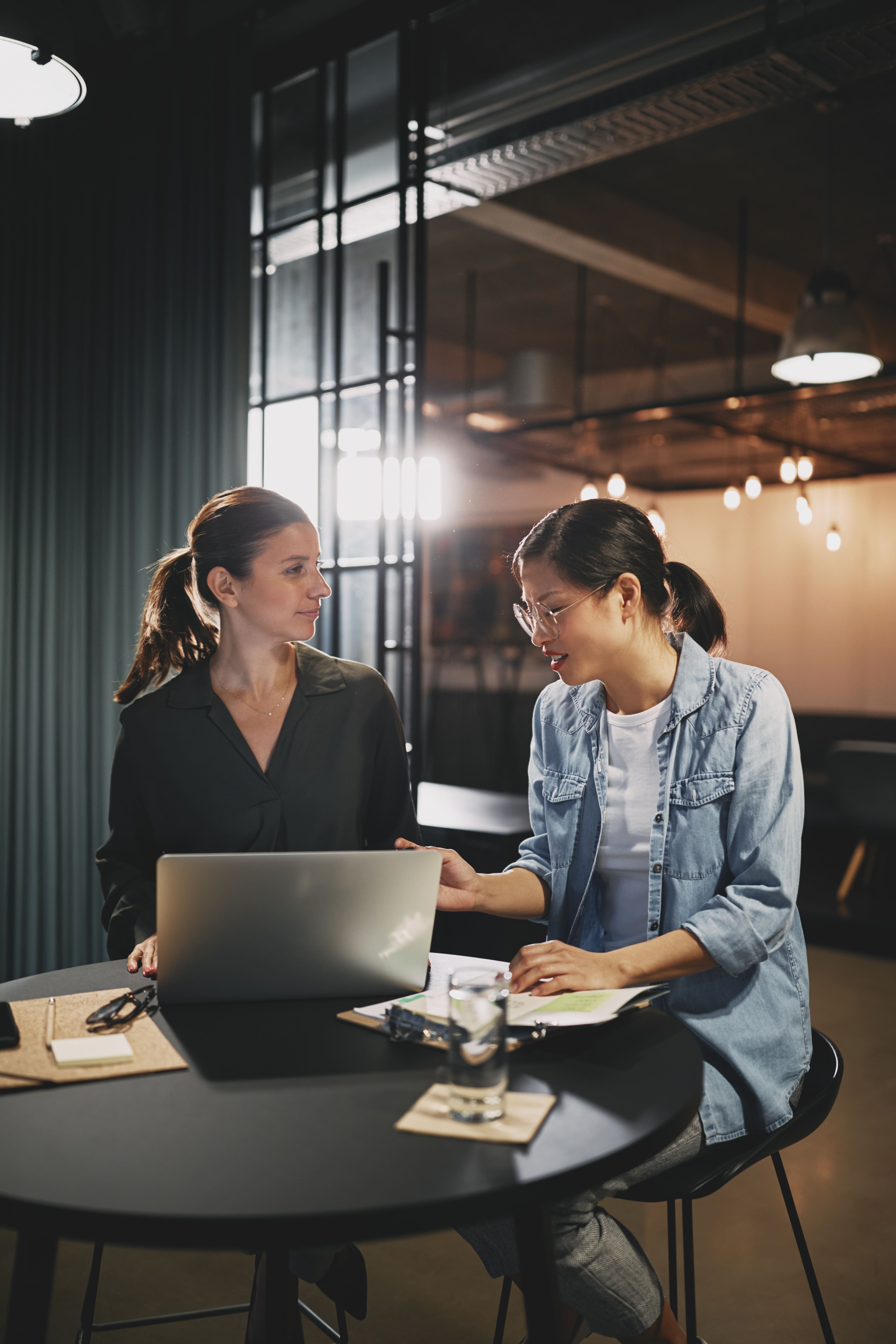 Two female team members discussing project